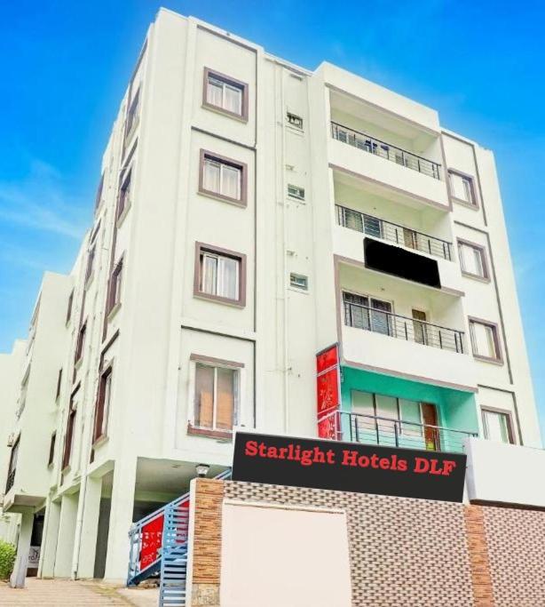 a tall white building with a sign in front of it at Hotel Starlight Chennai near DLF,L&T,Miot,Tradecenter,Ramachandra medical coll in Chennai