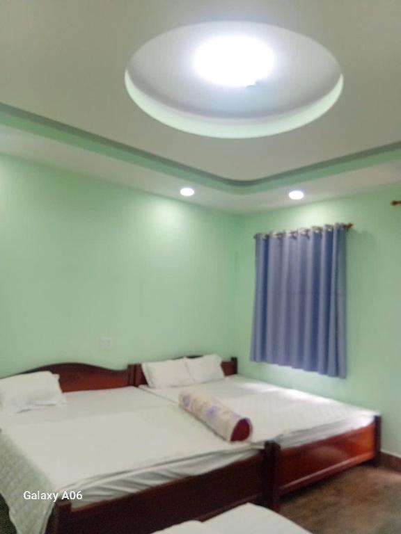 Postel nebo postele na pokoji v ubytování HOTEL MOTeL ĐỒNG KHỞI