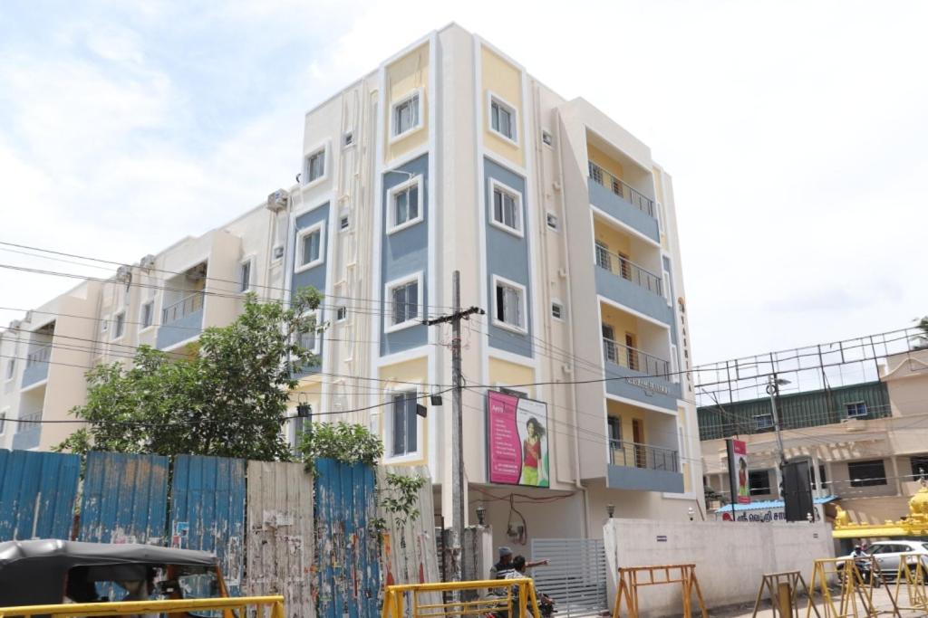 a tall building with a fence in front of it at Hotel Starlight Chennai near DLF,L&T,Miot,Tradecenter,Ramachandra medical coll in Chennai