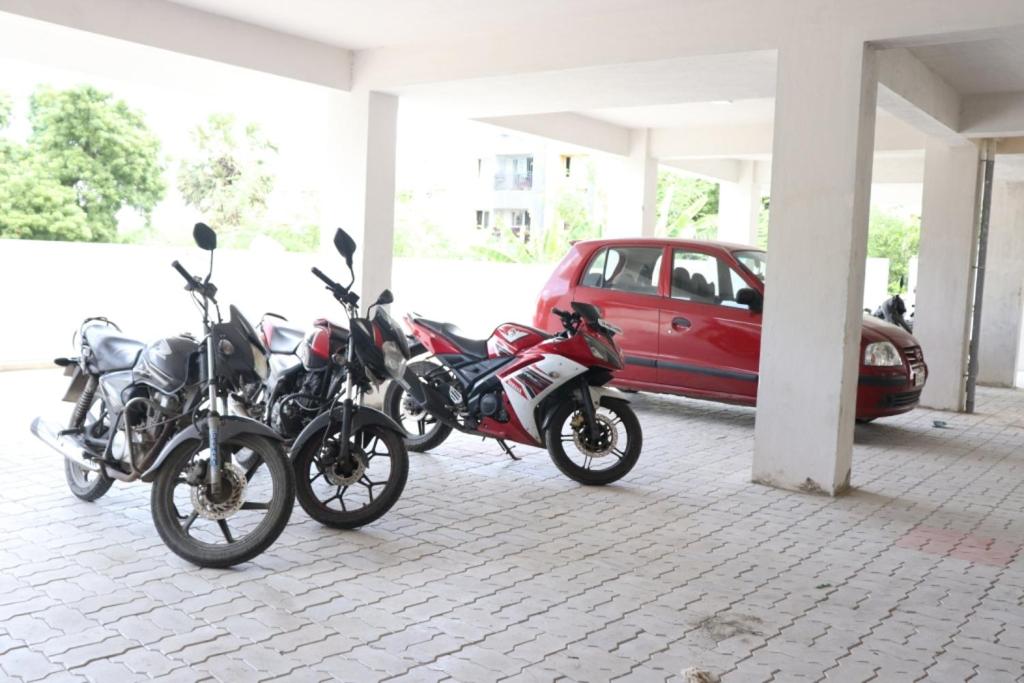 a group of motorcycles parked in a parking lot at Hotel Starlight Chennai near DLF,L&T,Miot,Tradecenter,Ramachandra medical coll in Chennai
