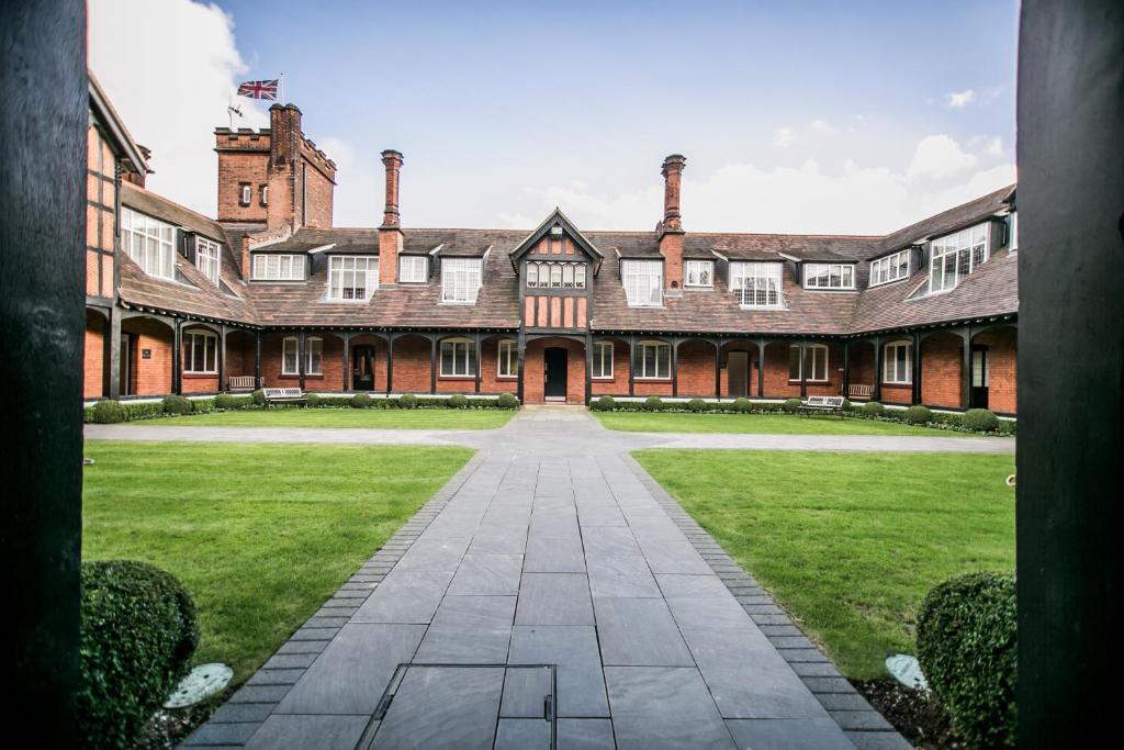 a large brick building with a grass courtyard at The Pillar Hotel in London