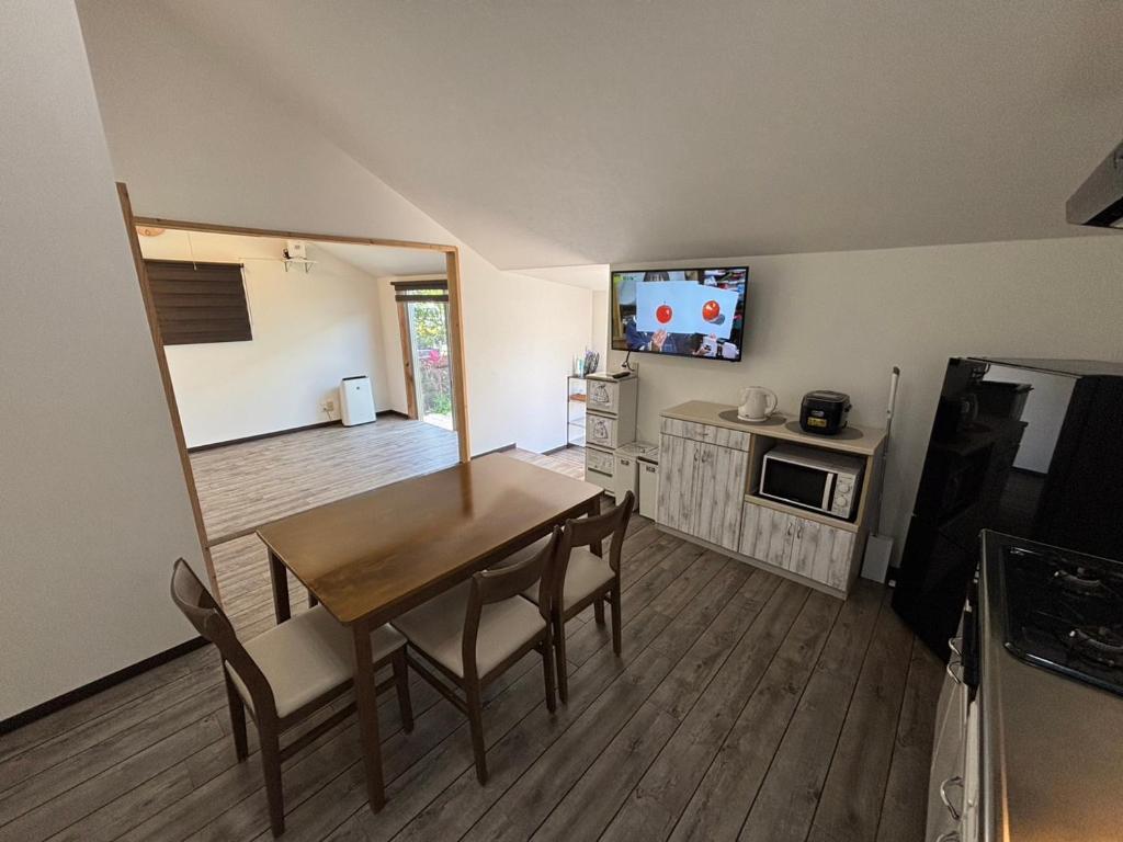 a living room with a dining room table and a kitchen at rupo green in Ishigaki Island