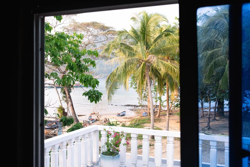 a view of the beach from a window at Lovesick Hostel & Bar Mpai Bay in Koh Rong Sanloem