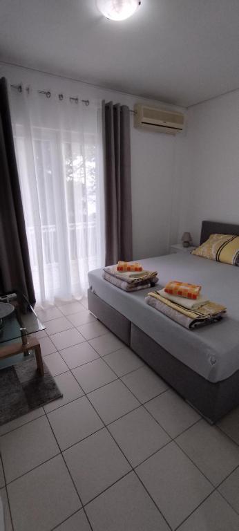 a bedroom with a bed with towels on it at DIN Ljubic in Mimice