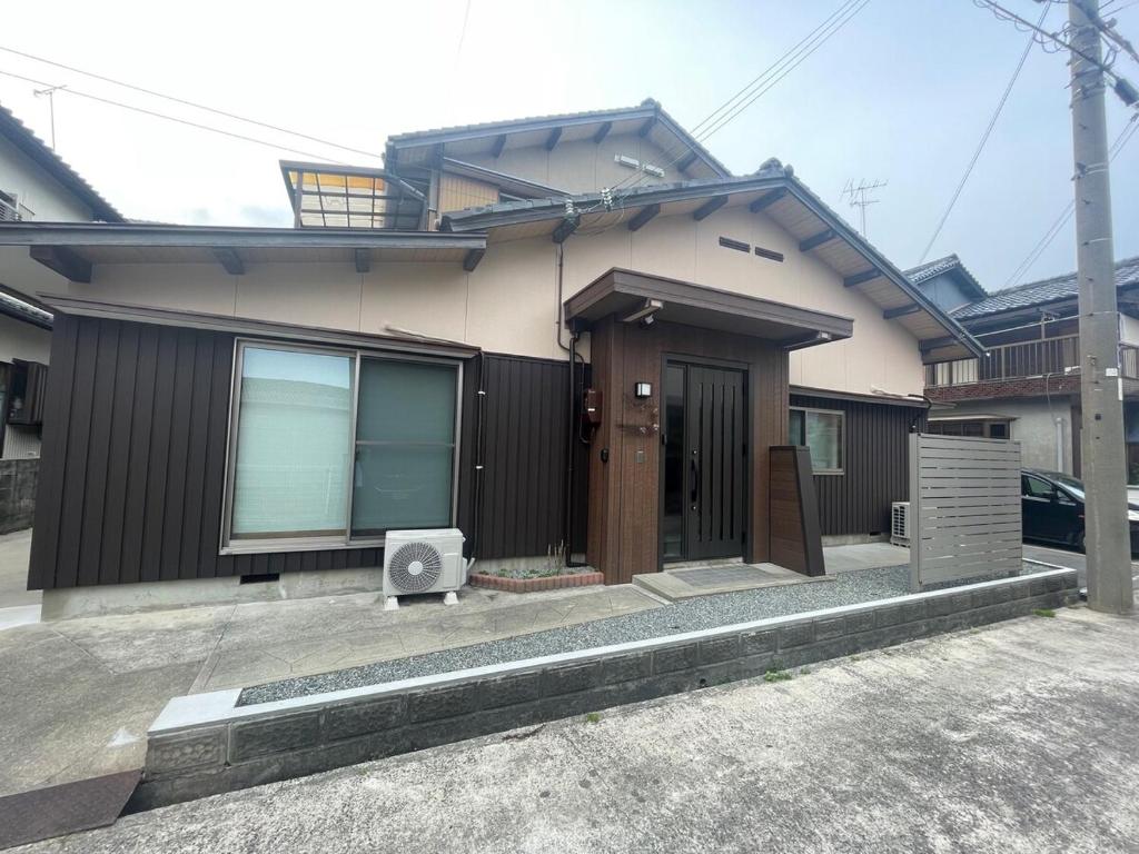 a house with a speaker sitting outside of it at Famille in Sumoto