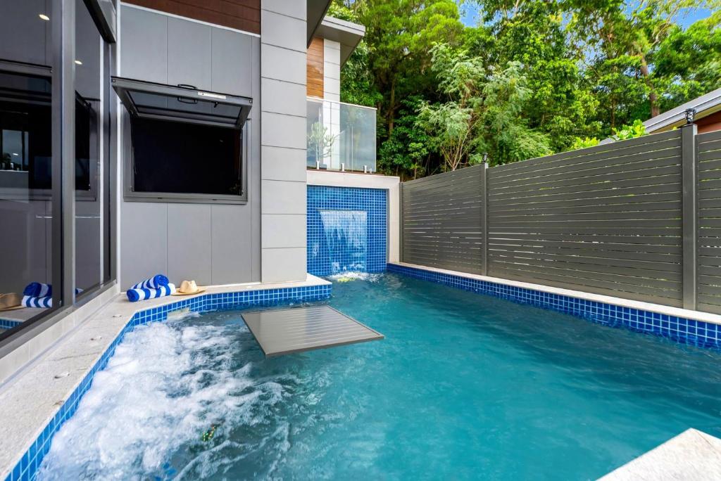 a swimming pool in the backyard of a house at Belle Escapes Bluewater Breeze in Trinity Beach