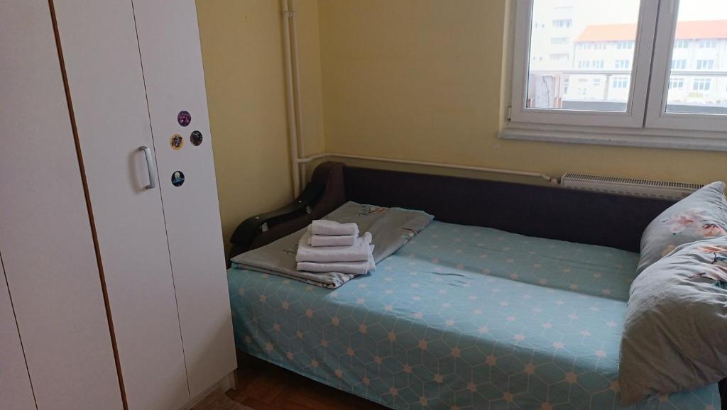 a small bed in a room with a window at Nisava rest in Niš