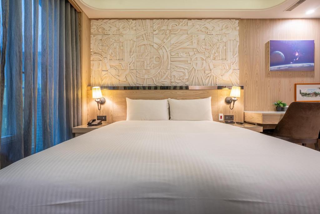 Postel nebo postele na pokoji v ubytování Guide Hotel Taichung Ziyou