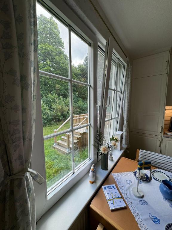 a window in a room with a table and a table sidx sidx at Large Swedish Countryside Villa with Garden & Nature Views In Kalmar in Abbetorp