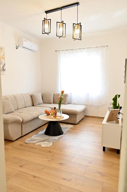 a living room with a couch and a table at Apartman KALINA in Bileća
