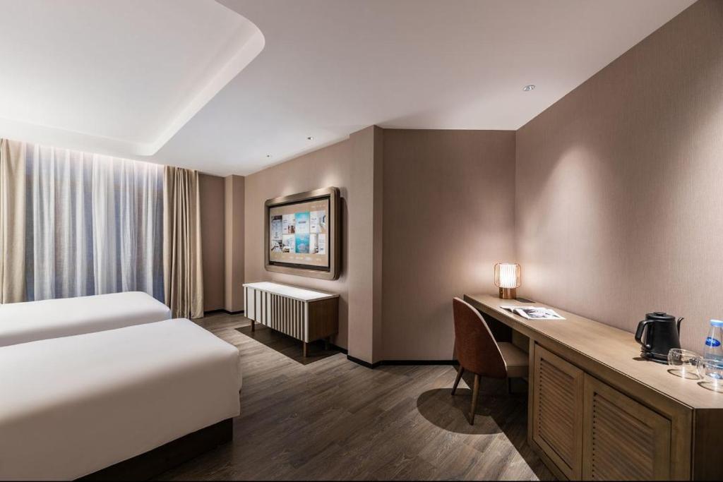 Postel nebo postele na pokoji v ubytování Crystal Orange Shanghai Safari Park Hotel