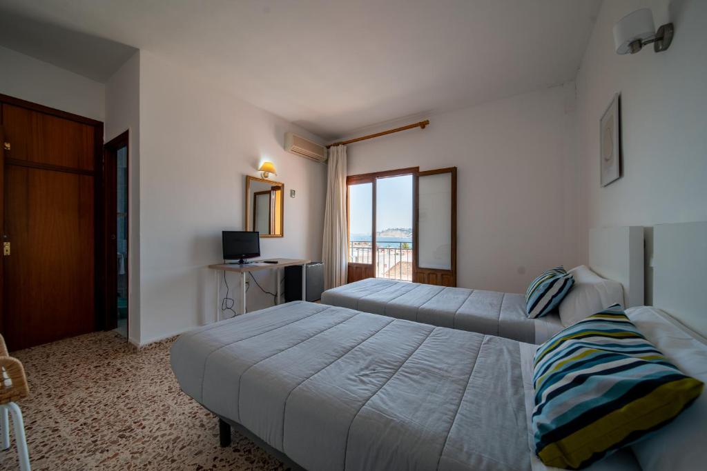 Cama ou camas em um quarto em Hotel Buigues