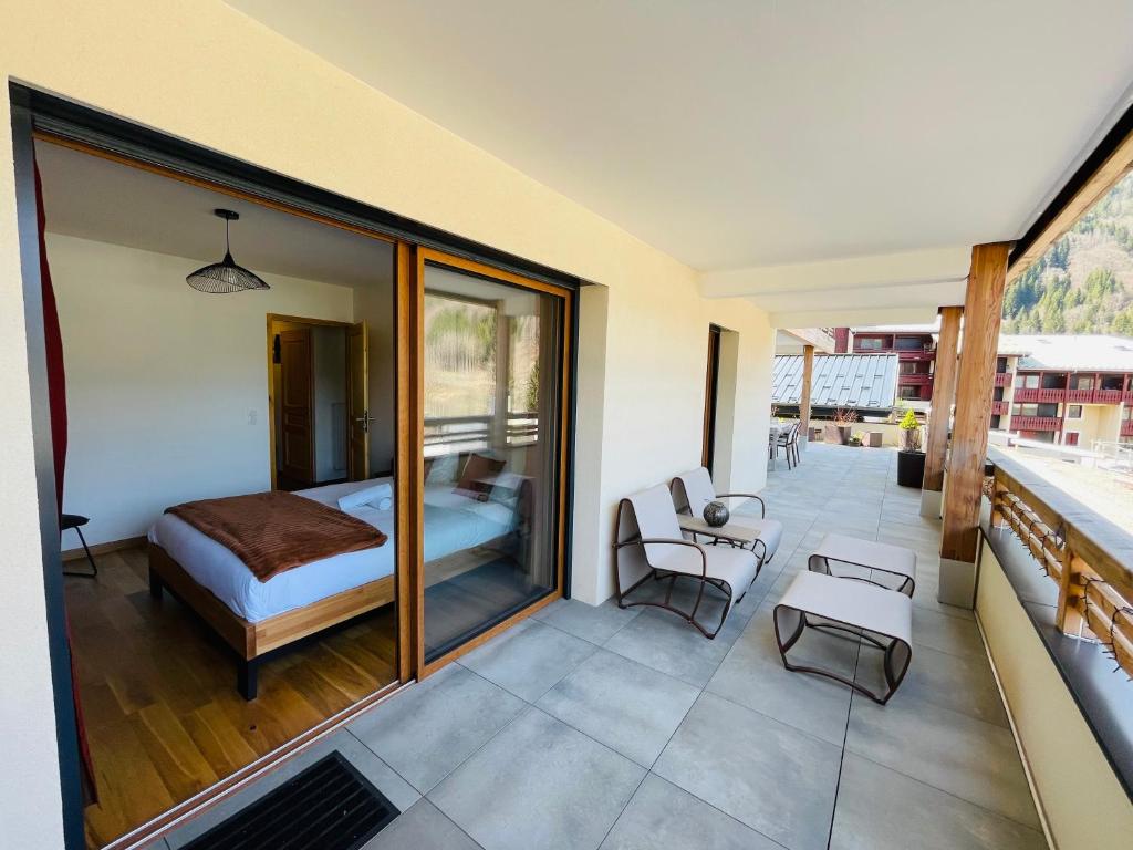 een slaapkamer met een bed op een balkon bij Le RandAulps in Saint-Jean-dʼAulps