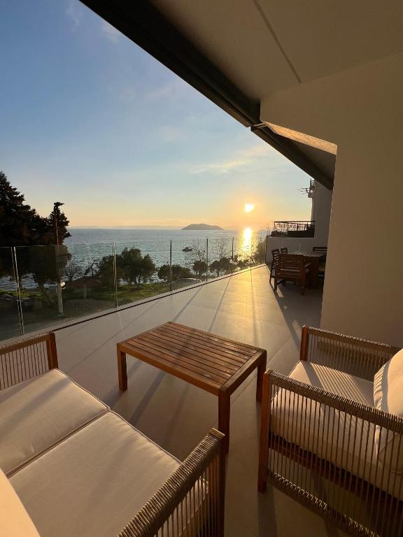 a balcony with a table and a view of the ocean at Apartments-M4 in Neos Marmaras