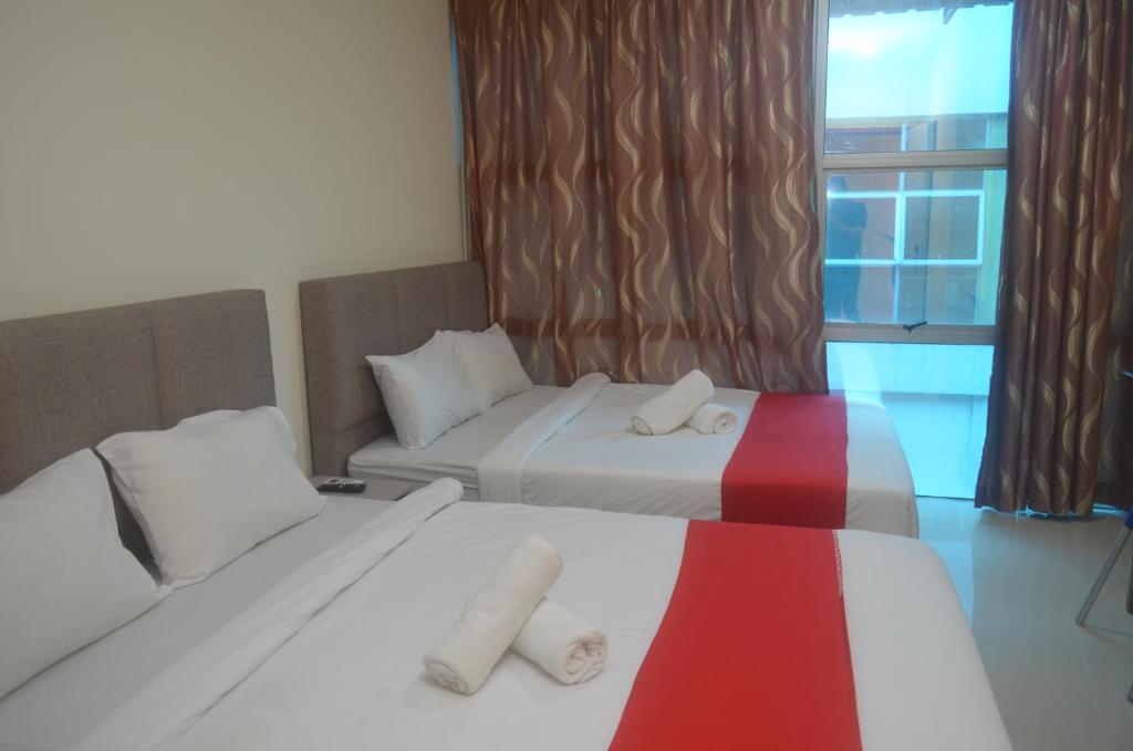 Postel nebo postele na pokoji v ubytování KL Empire Hotel KLIA, Formerly known as Adiff Palace KLIA
