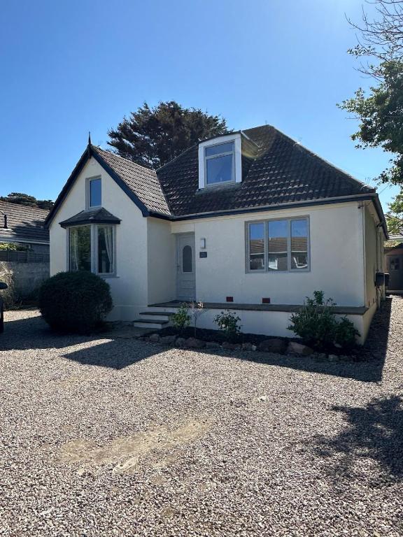 a white house with a gravel driveway at Luxury, Tranquillity Near Beach in Carbis Bay