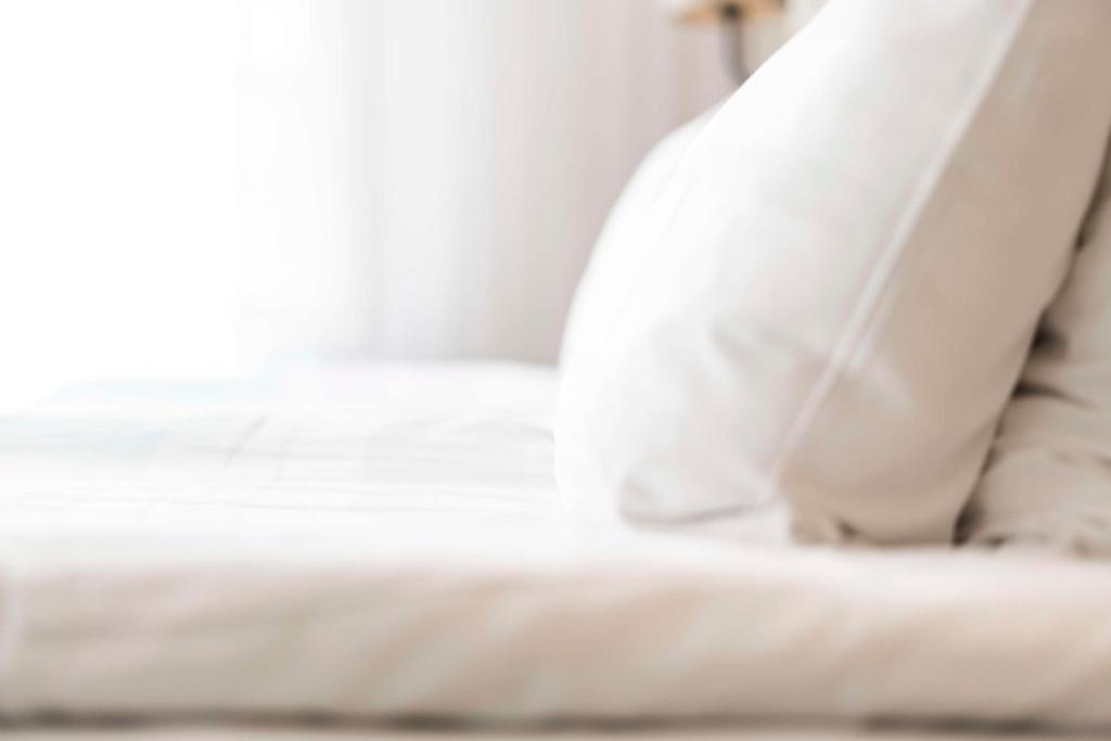 a close up of a white bed in a room at Scandic Stavanger Airport in Sola