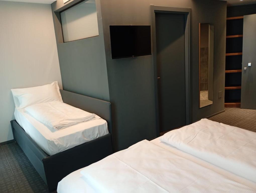 Postel nebo postele na pokoji v ubytování WEGA Hotel Verona