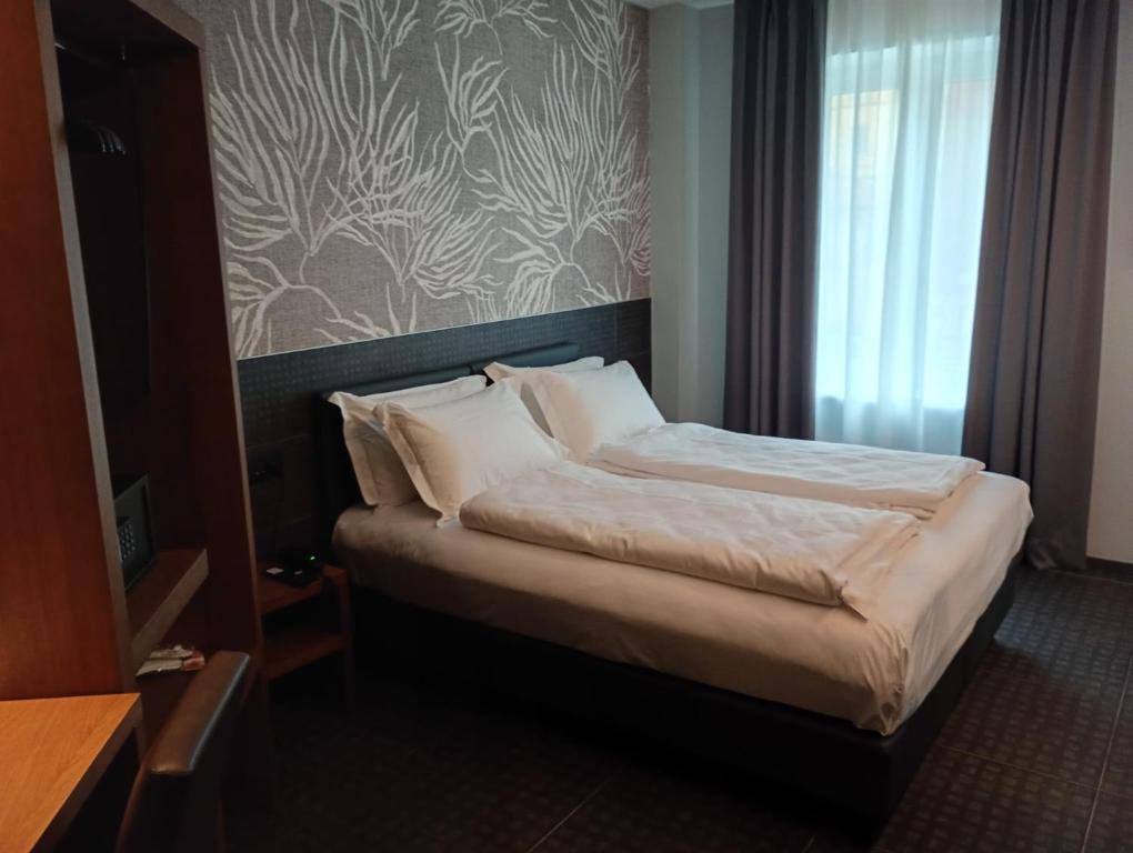 Postel nebo postele na pokoji v ubytování WEGA Hotel Verona
