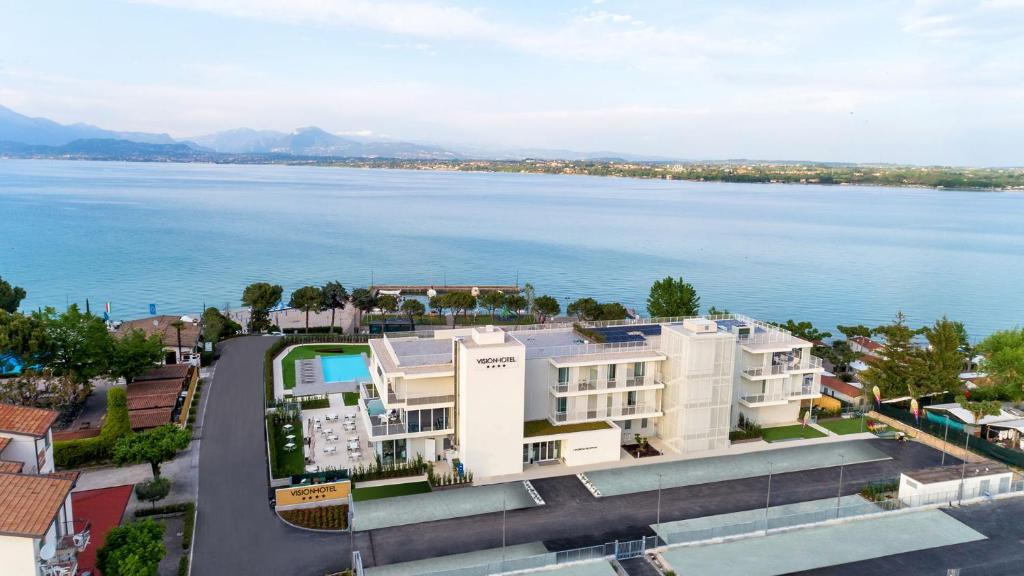 an aerial view of a building next to the water at Vision Hotel in Peschiera del Garda