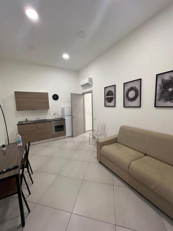 a living room with a couch and a table at Casa Vacanze Nemesi AURA in Salerno