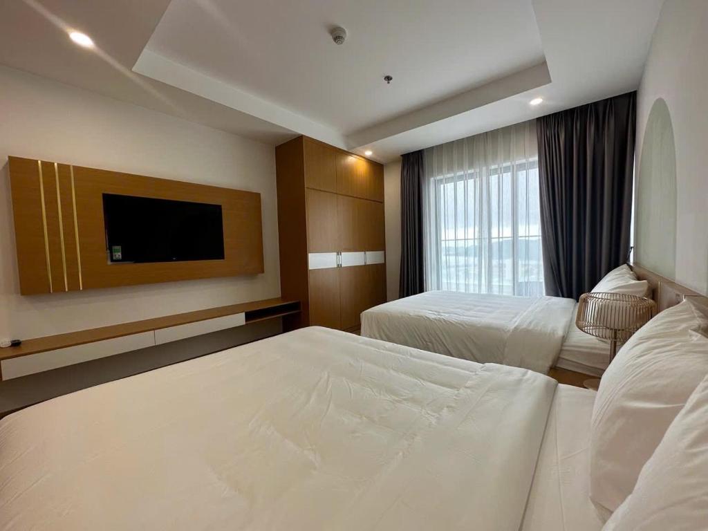 Giường trong phòng chung tại TMS Quy Nhơn Luxury Homestay