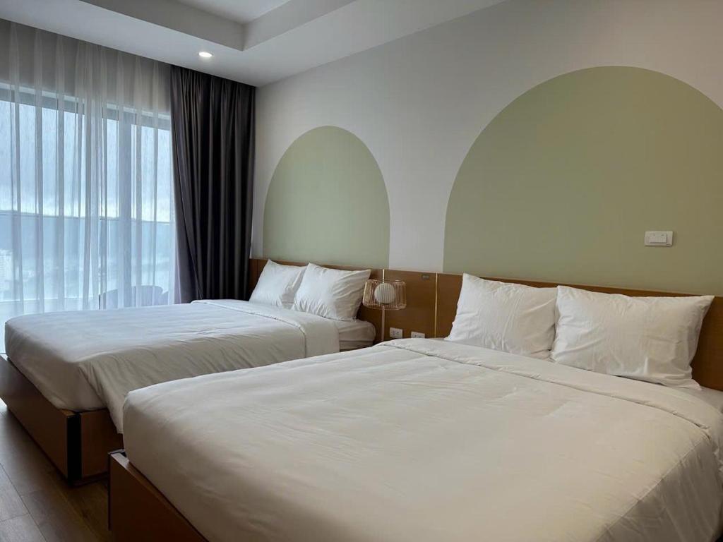 Giường trong phòng chung tại TMS Quy Nhơn Luxury Homestay