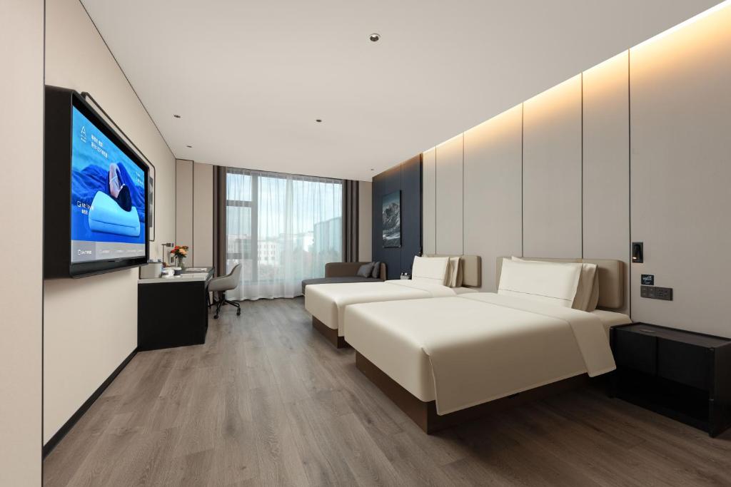 Postel nebo postele na pokoji v ubytování Atour Hotel Tianjin Tiankai Huayuan Industrial Park
