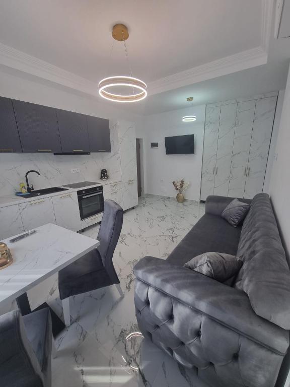 a living room with a couch and a table at Gonbuilding Residence in Suceava