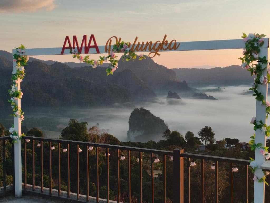 a gate with a view of a misty mountain at อามา ภูลังกา เฮาส์ in Ban Sakoen