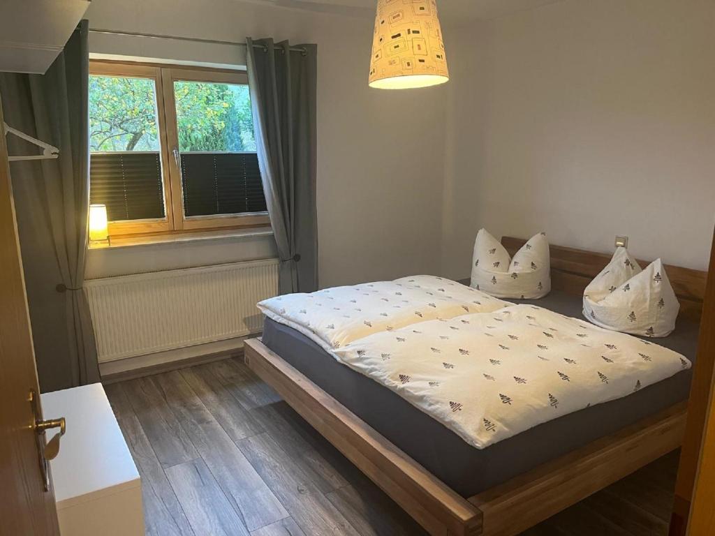 a bedroom with a bed and a window at Ferienwohnung Klara in Hilchenbach