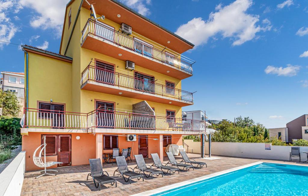 a building with a swimming pool next to a house at Villa with pool Riviera in Crikvenica