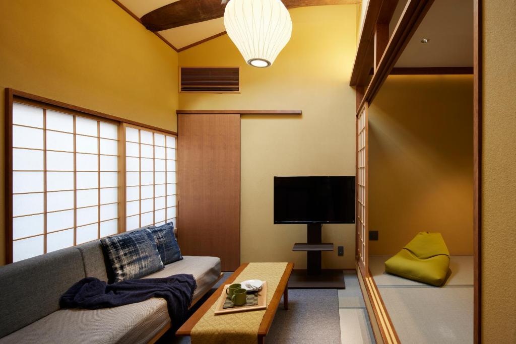 a living room with a couch and a tv at Minn Nijo-jo in Kyoto