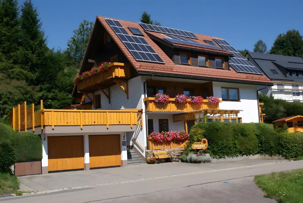 a house with solar panels on the roof at Haus Rosenfelder Fewo Abendsonne in Bernau im Schwarzwald