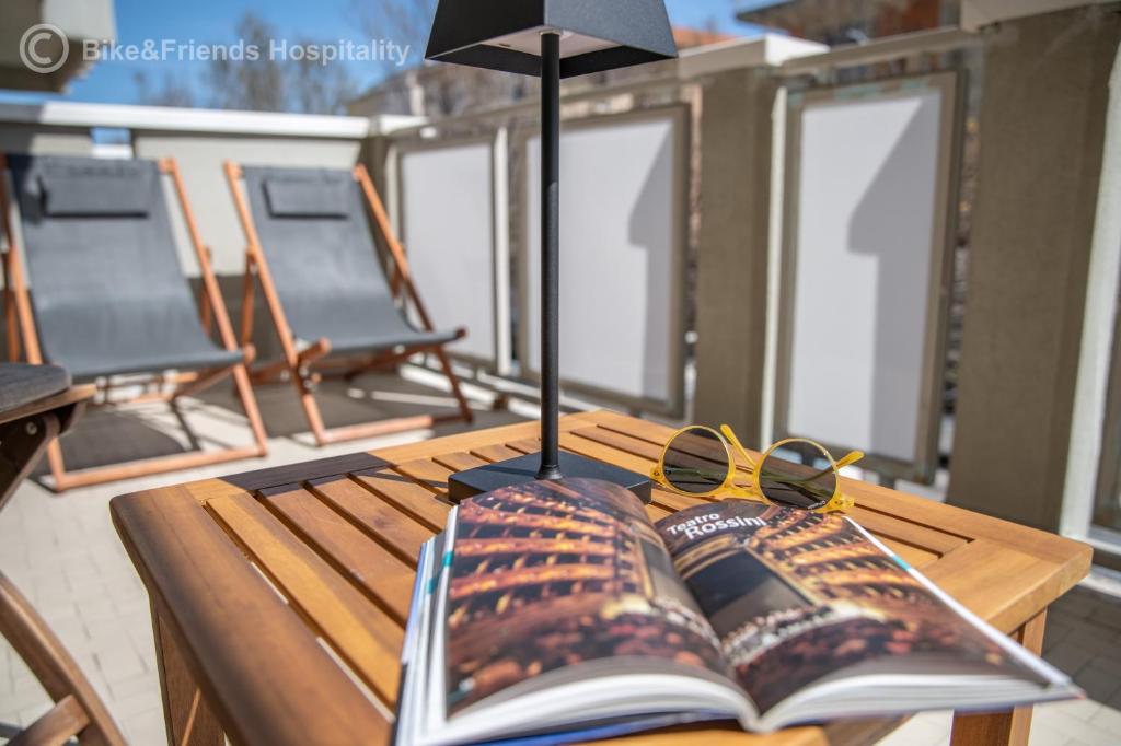 a book on a table with a pair of glasses on it at Living Dante 41 in Pesaro