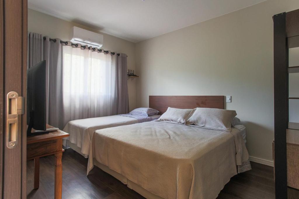 Postel nebo postele na pokoji v ubytování Villaggio dos Pássaros