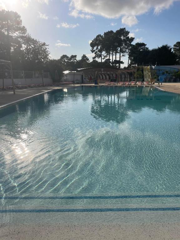 a large swimming pool with blue water at mobil home neuf du samedi au samedi in Lège-Cap-Ferret