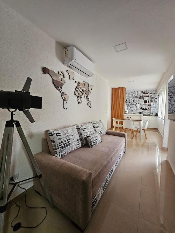 a living room with a couch and a tv in a room at Departamento 12 Tower in Salta