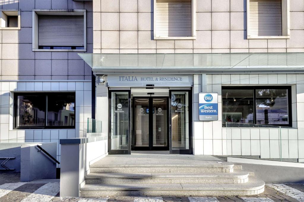a building with the entrance to a train trial agency at Best Western Hotel Residence Italia in Quartu SantʼElena