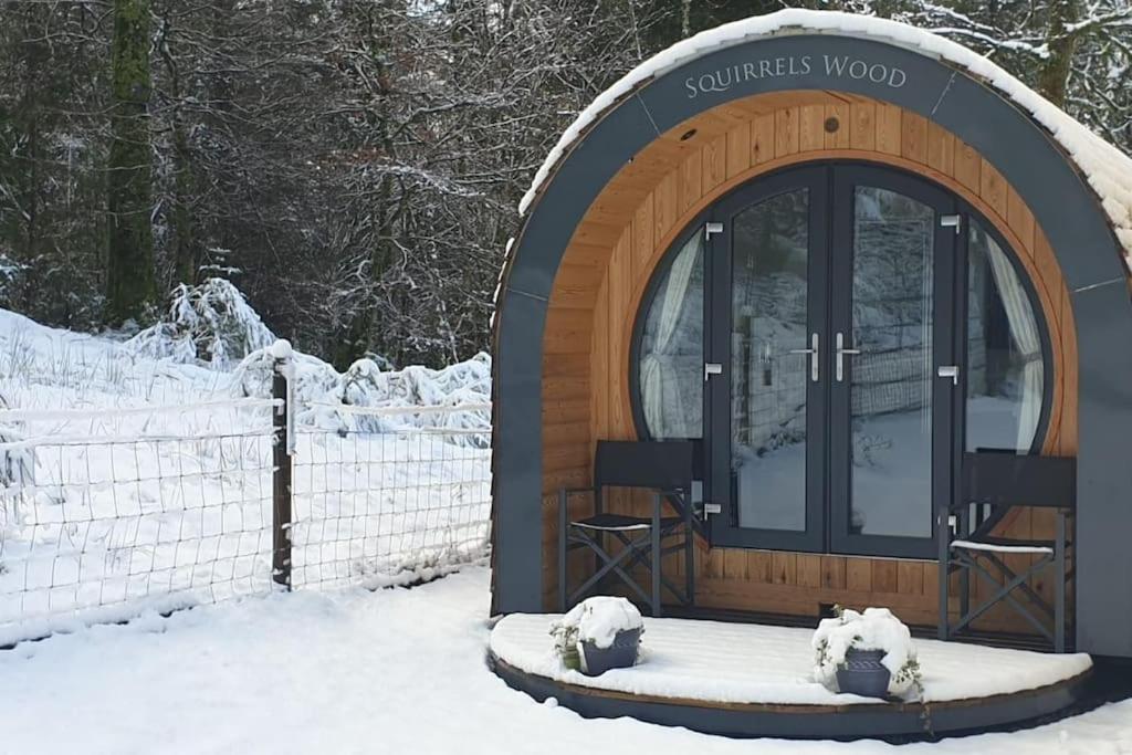 a gazebo in the snow next to a fence at Squirrels Wood Lodge, nr Glencoe, dog friendly in Acharra