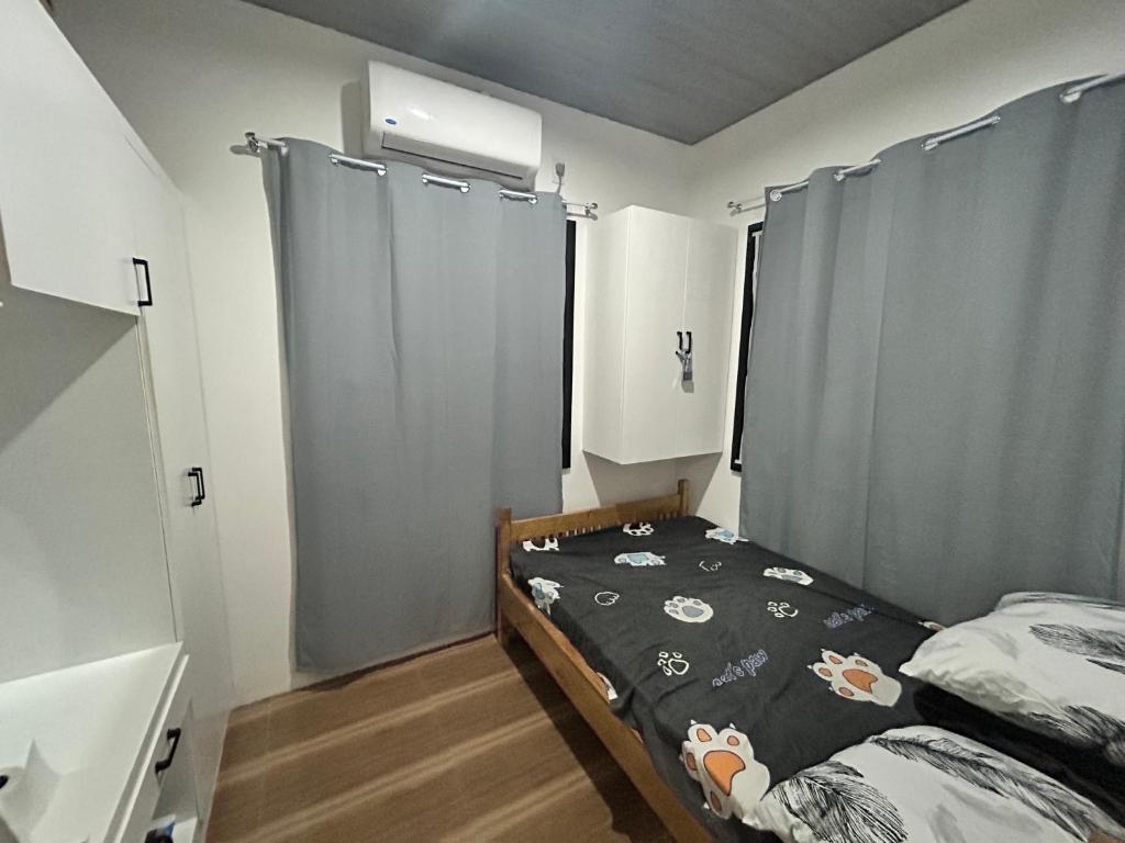 a small bedroom with a bed and a window at Langlang house in Dutunan