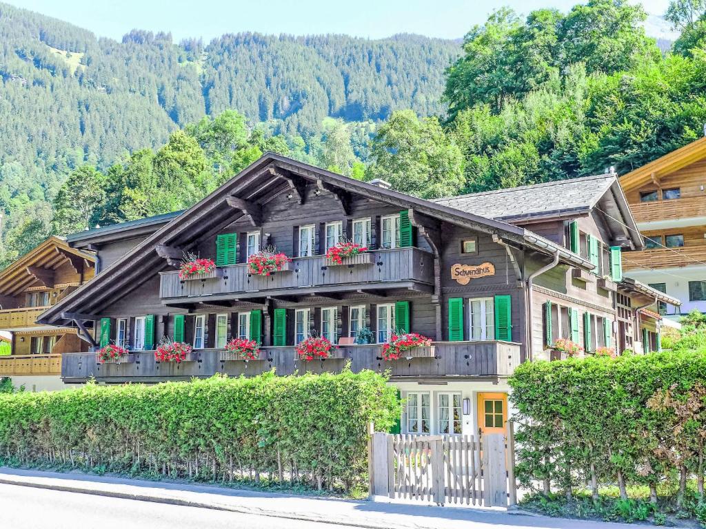 a house with flowers on the balconies of it at Apartment Chalet Schwendihus-11 by Interhome in Grindelwald