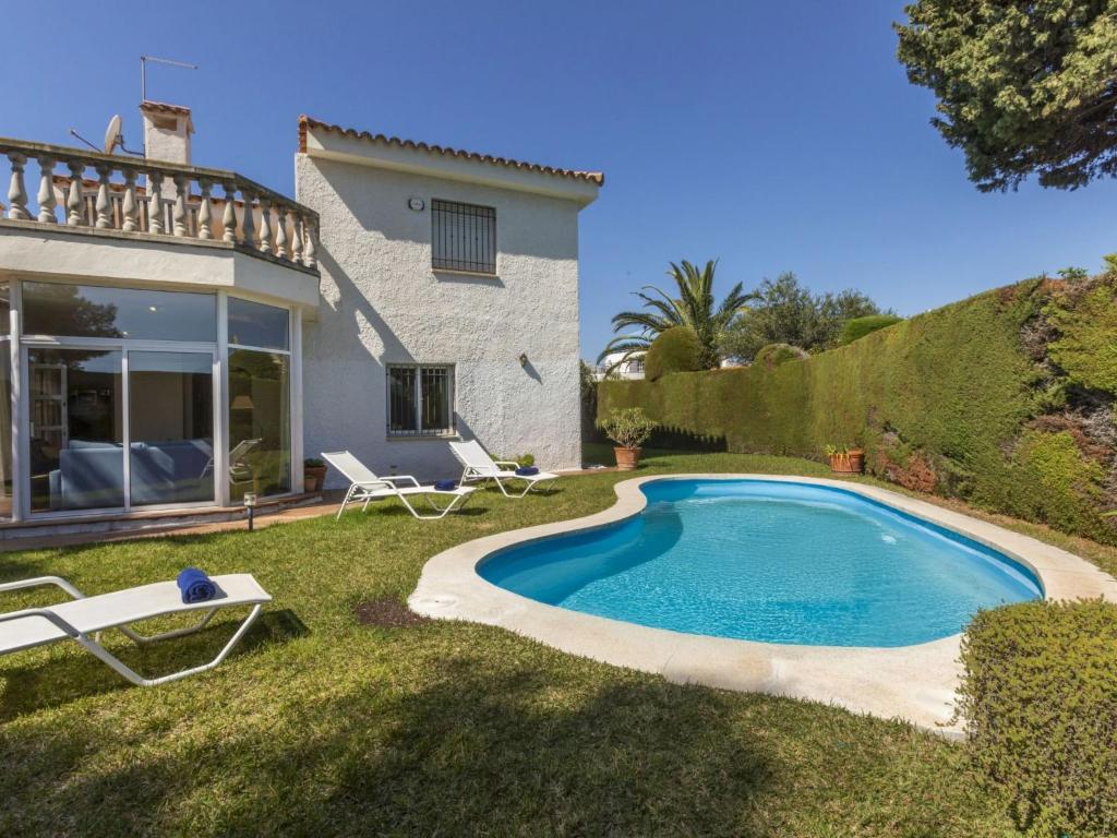 a swimming pool in the yard of a house at Holiday Home Serge by Interhome in Cambrils