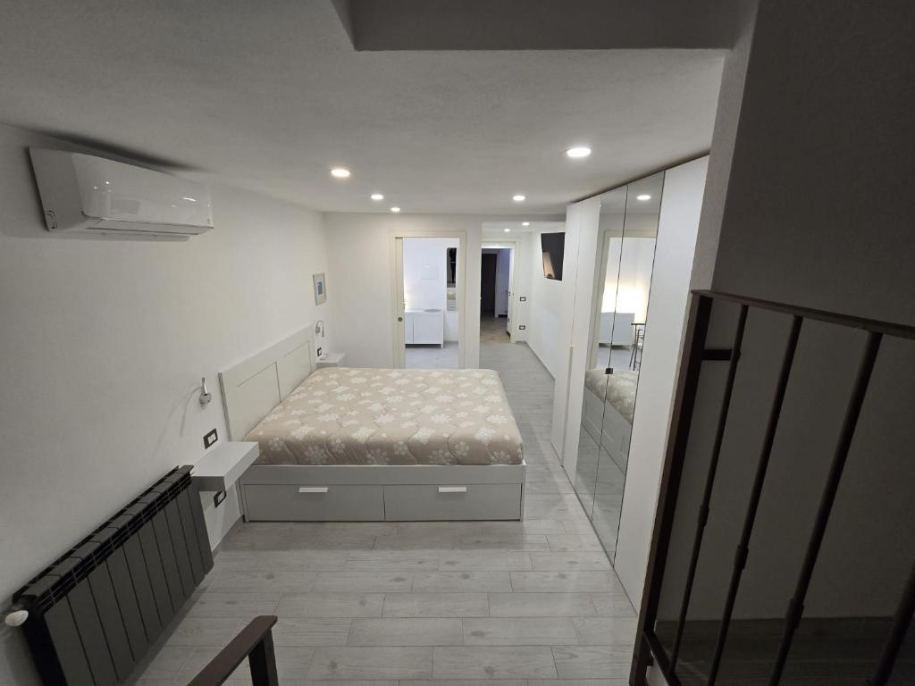 a bedroom with a bed in the middle of a hallway at Suite nel centro storico di Cagliari in Cagliari