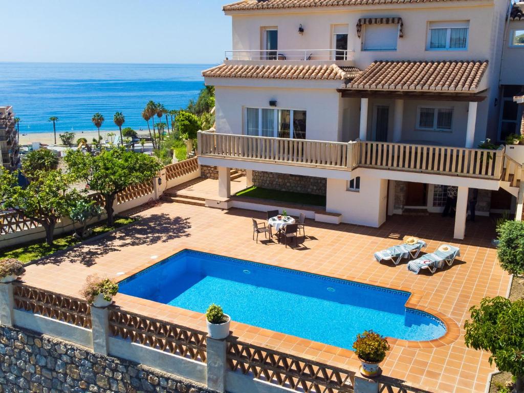 a villa with a swimming pool and the ocean at Villa Cerro de Mariote by Interhome in Almuñécar