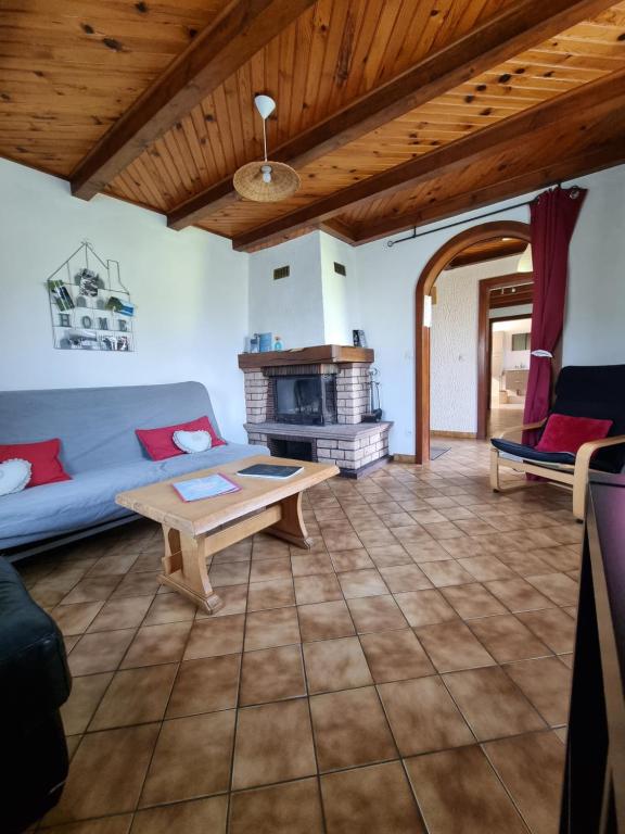 a living room with a couch and a table at La Mauselaine in Gerbépal