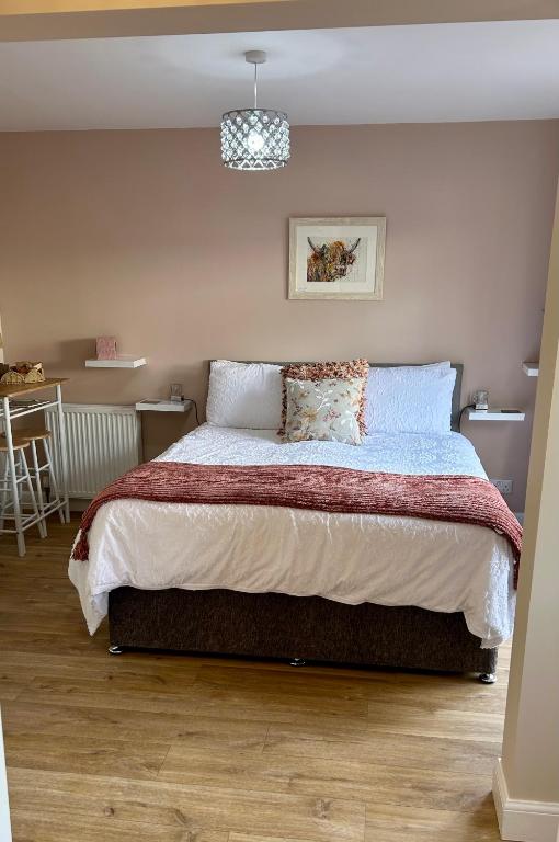 a bedroom with a large bed in a room at Stepping Stone in Fort William