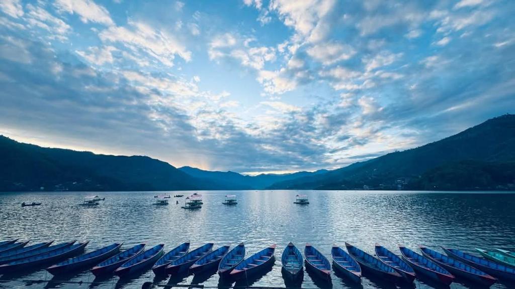 a large body of water with boats in it at Hotel Fewa Lake View in Pokhara