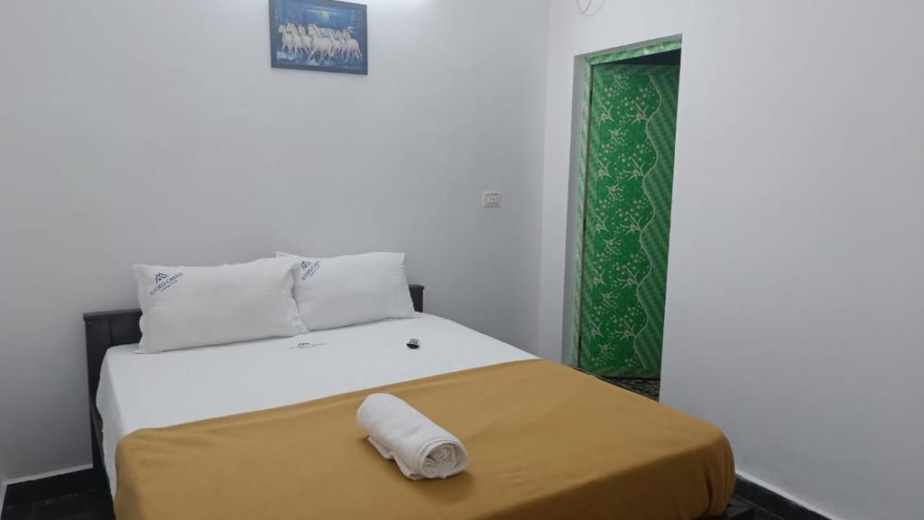 a bed in a room with a green door at Ilford Castle Home Stay Pondicherry in Puducherry