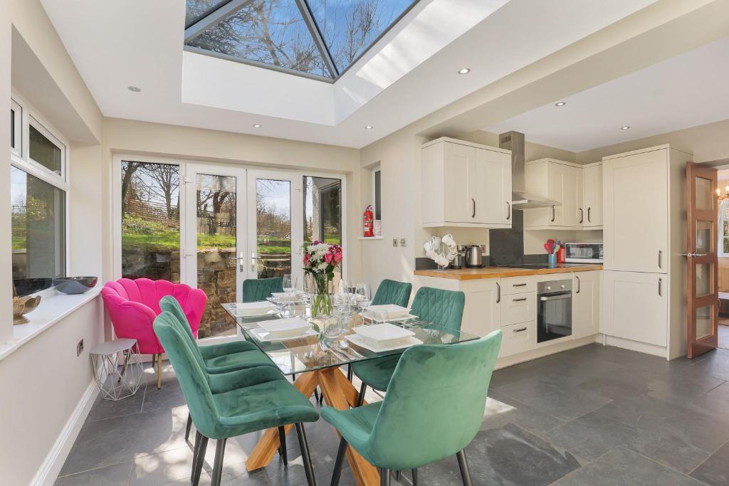 a kitchen and dining room with a table and chairs at Spindlestone Cottage - North East Escapes in Bamburgh